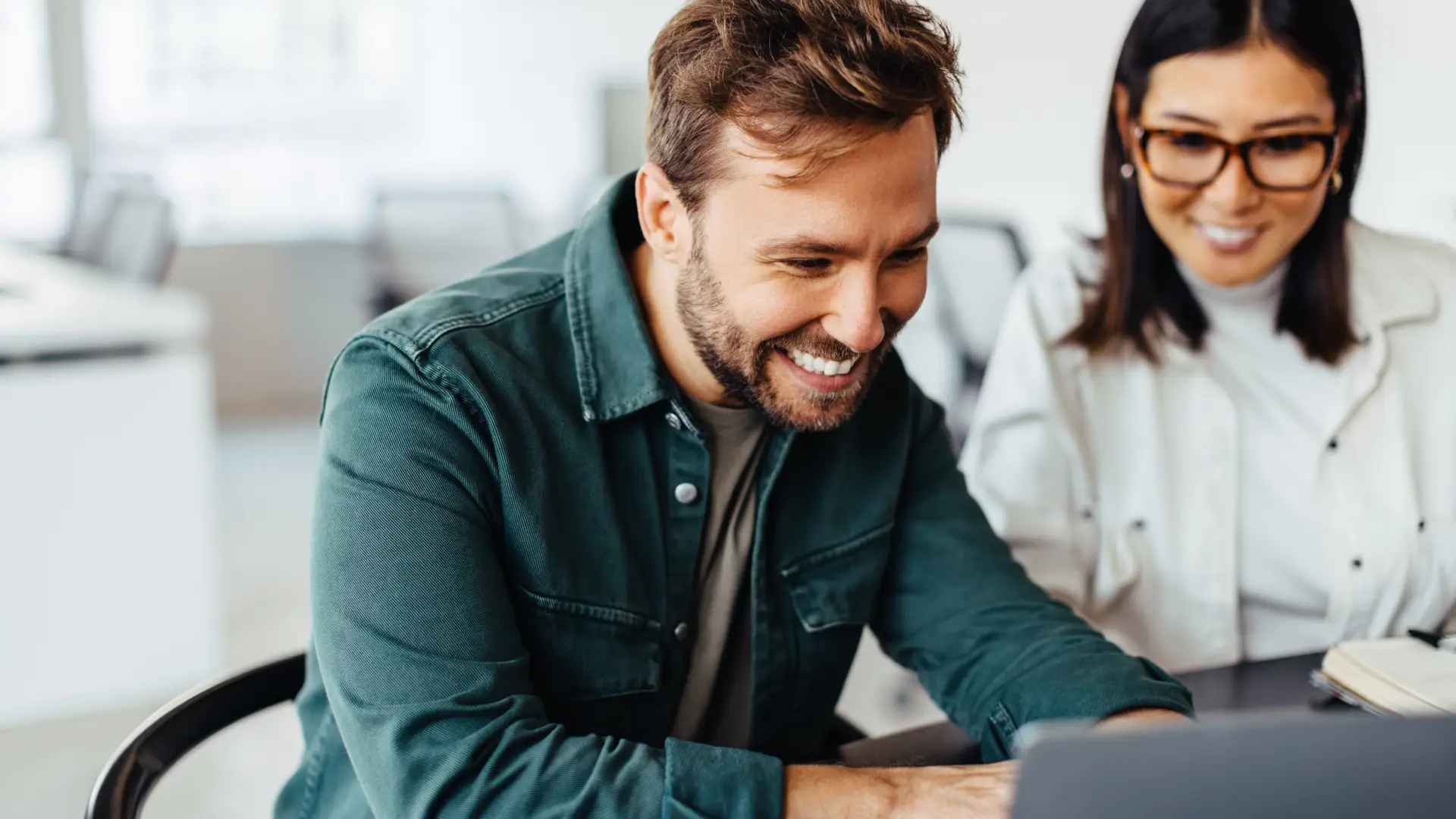 Young couple usign their laptop to discover Asda deals bundles