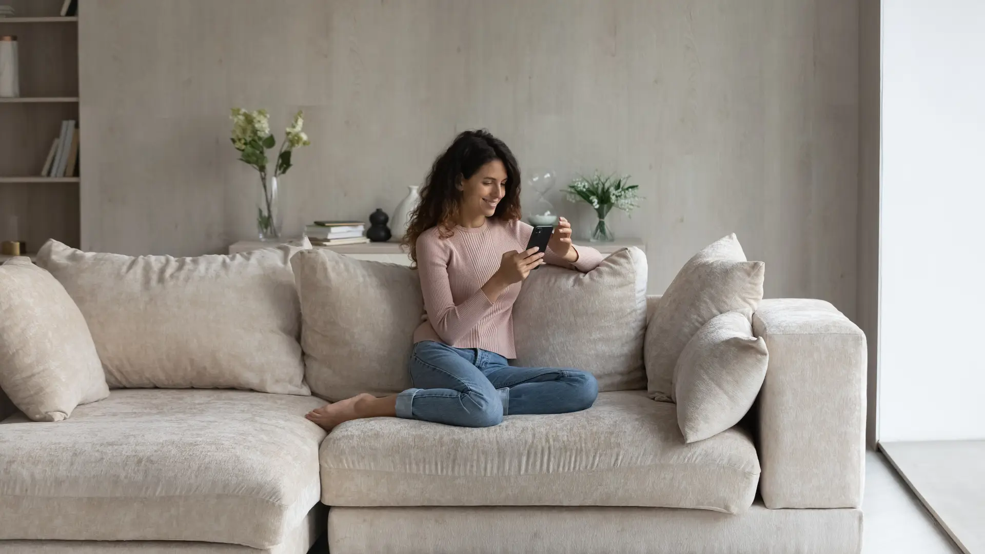 Young women at the sofa checking Asda app