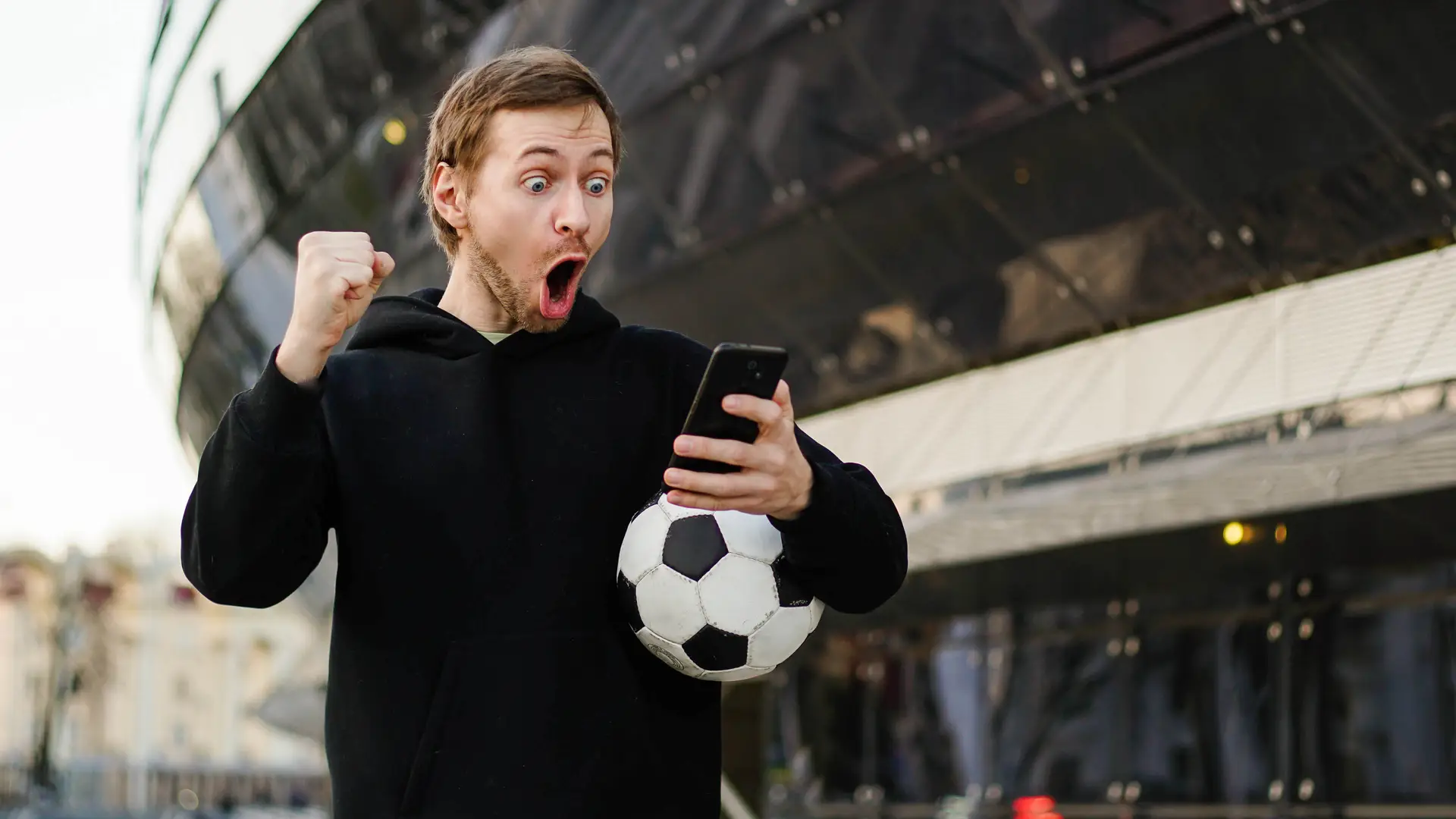 Boy celebrating a goal with his phone because he knows how to cast BT sport