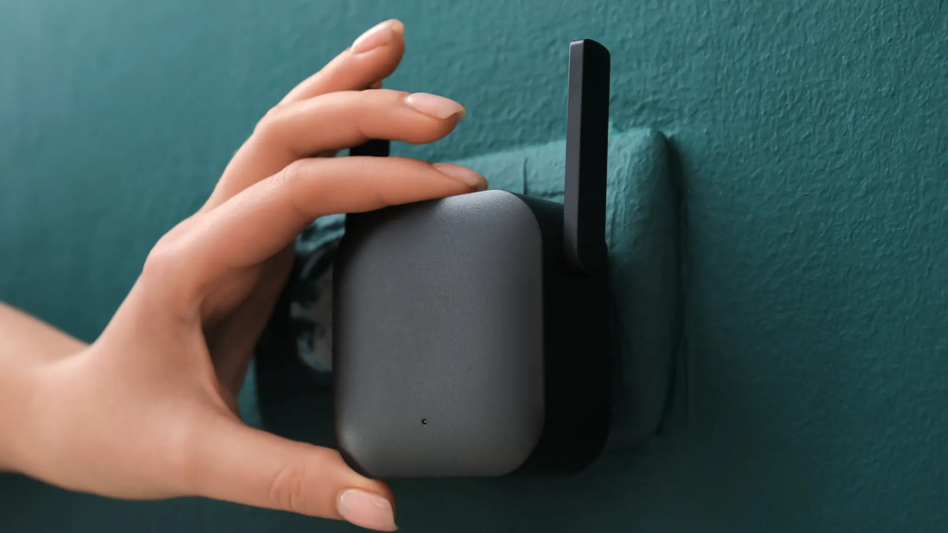 Girl hand installing a wifi extender with BT