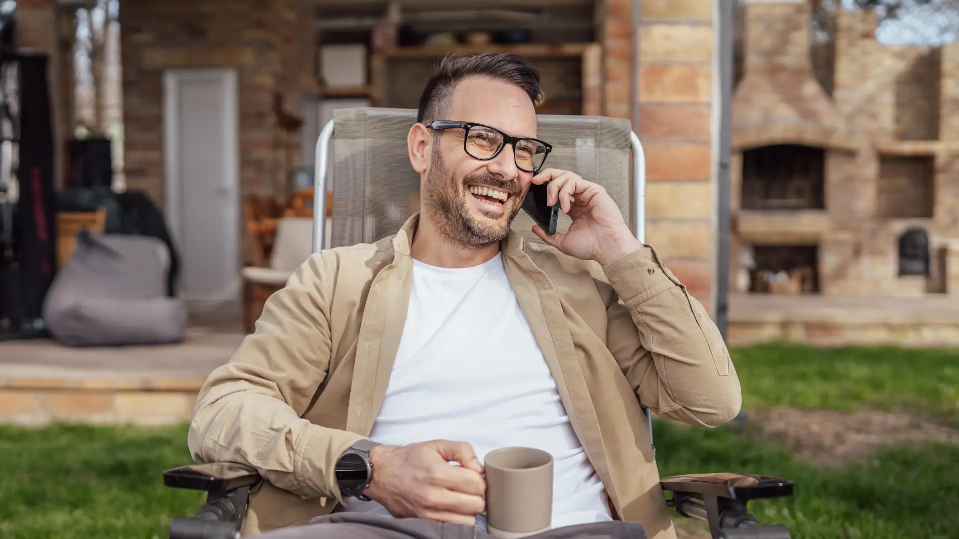 Happy man talking on his phone because he has the best mobile coverage 