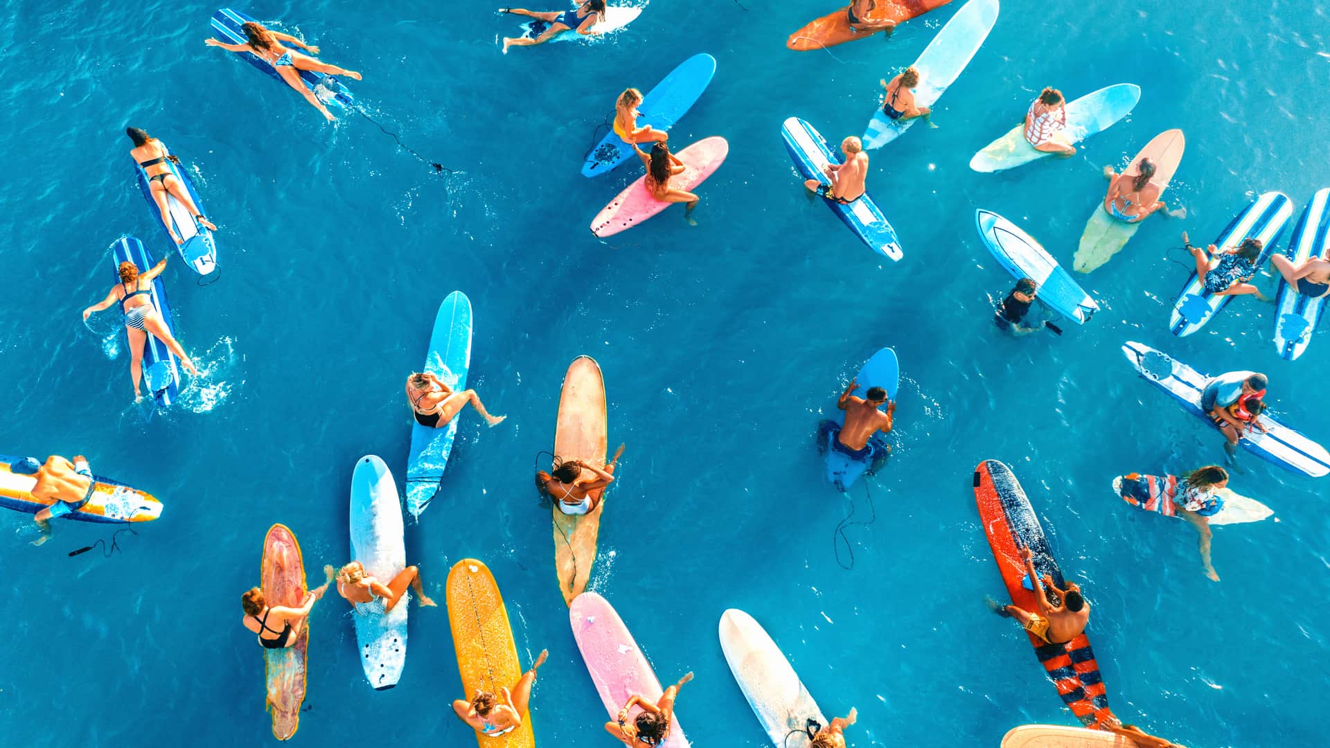 People on surfboards in the ocean to represent the internarional deals in Hawaii