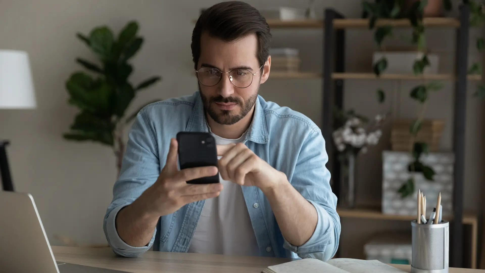 Man looking at his phone searching about international deals 