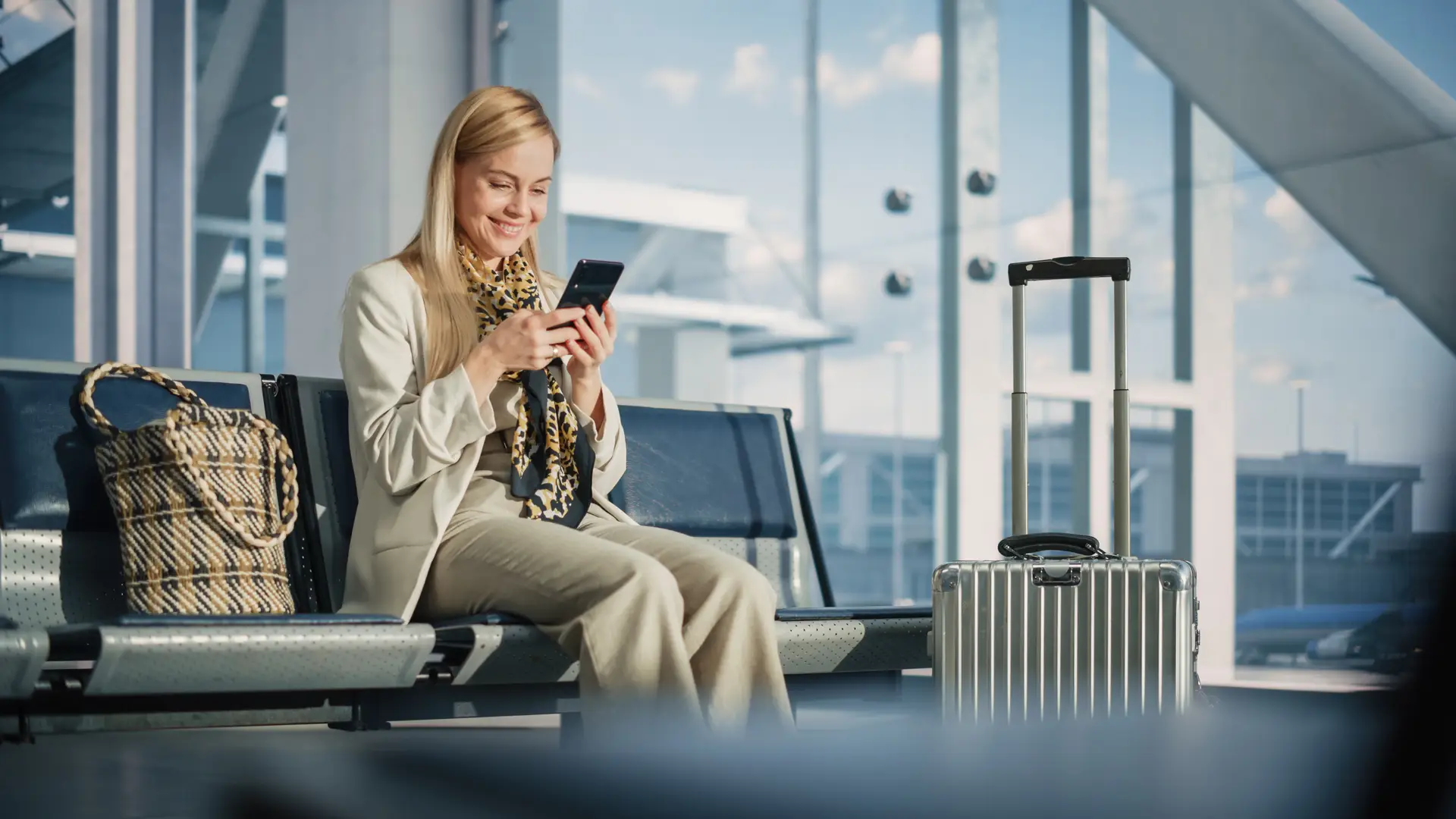 Happy girl at the sofa checking the conditions of roaming after brexit 