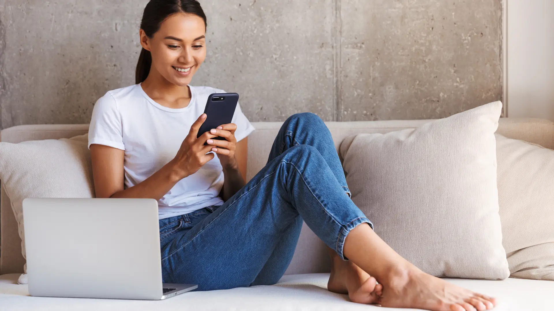 Young women at the sofa checking Plusnet app