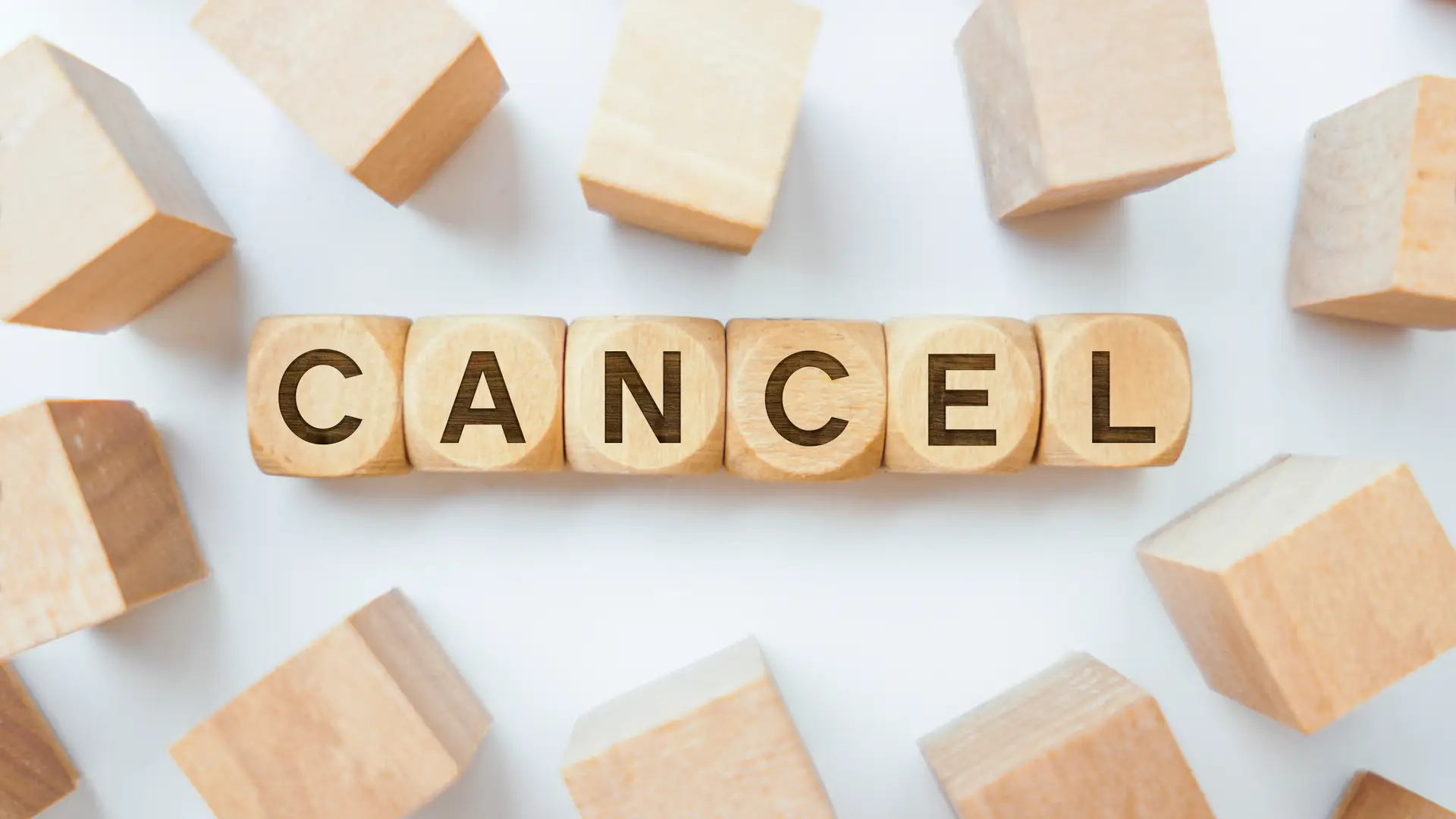 Word cancel on wooden cubes representing the cancellation of plusnet plans