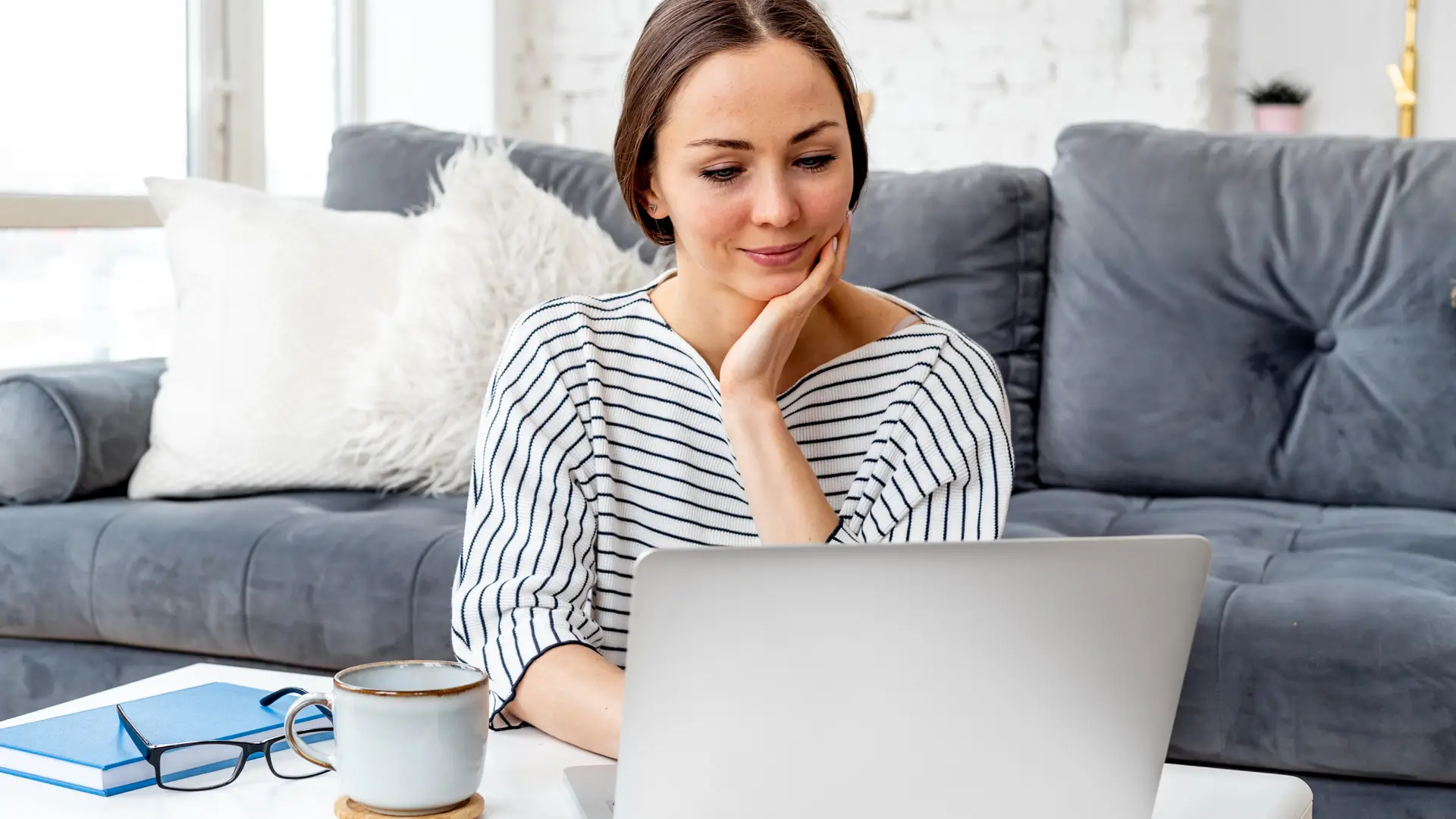 Young women checking on her laptop the Virginmedia billing