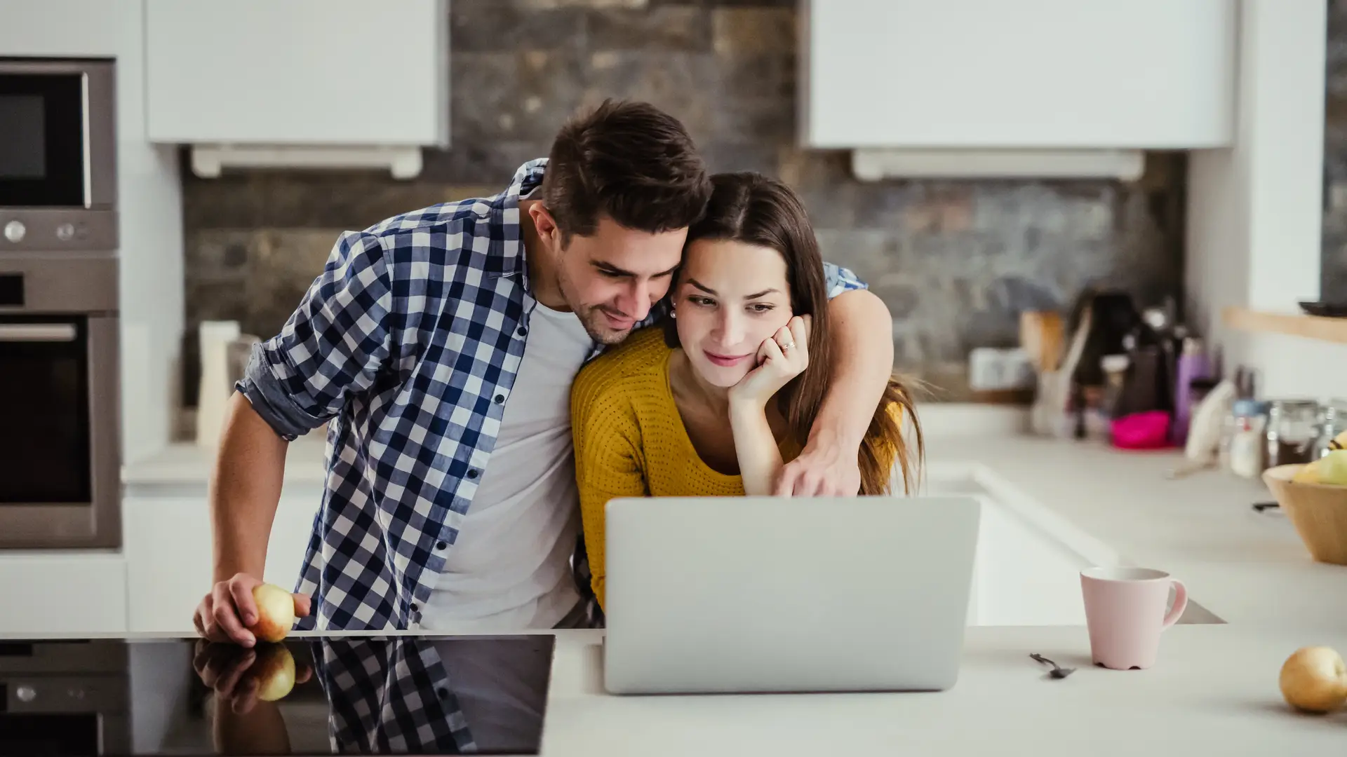 Young couple using heir laptop beacuase ther have a Virginemdia router