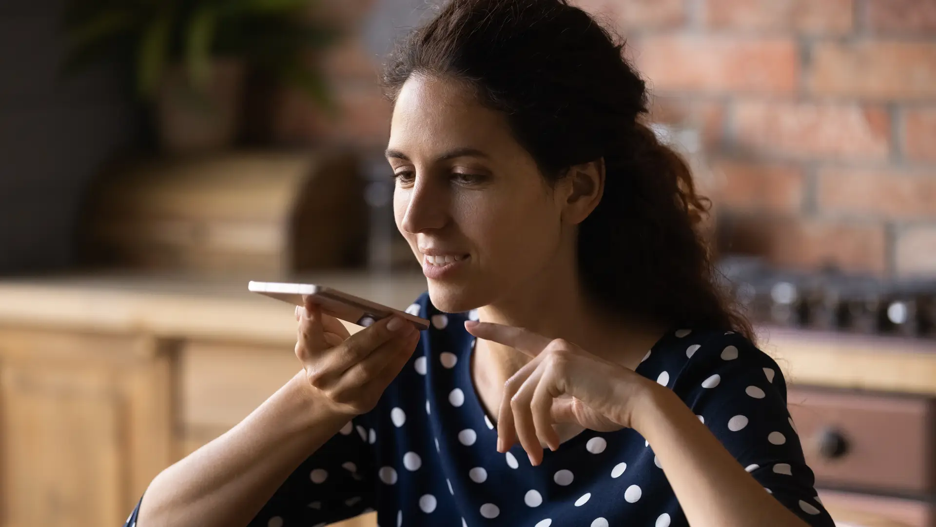 Young woman leaving a Virginmedia voicemail on her friend's mobile