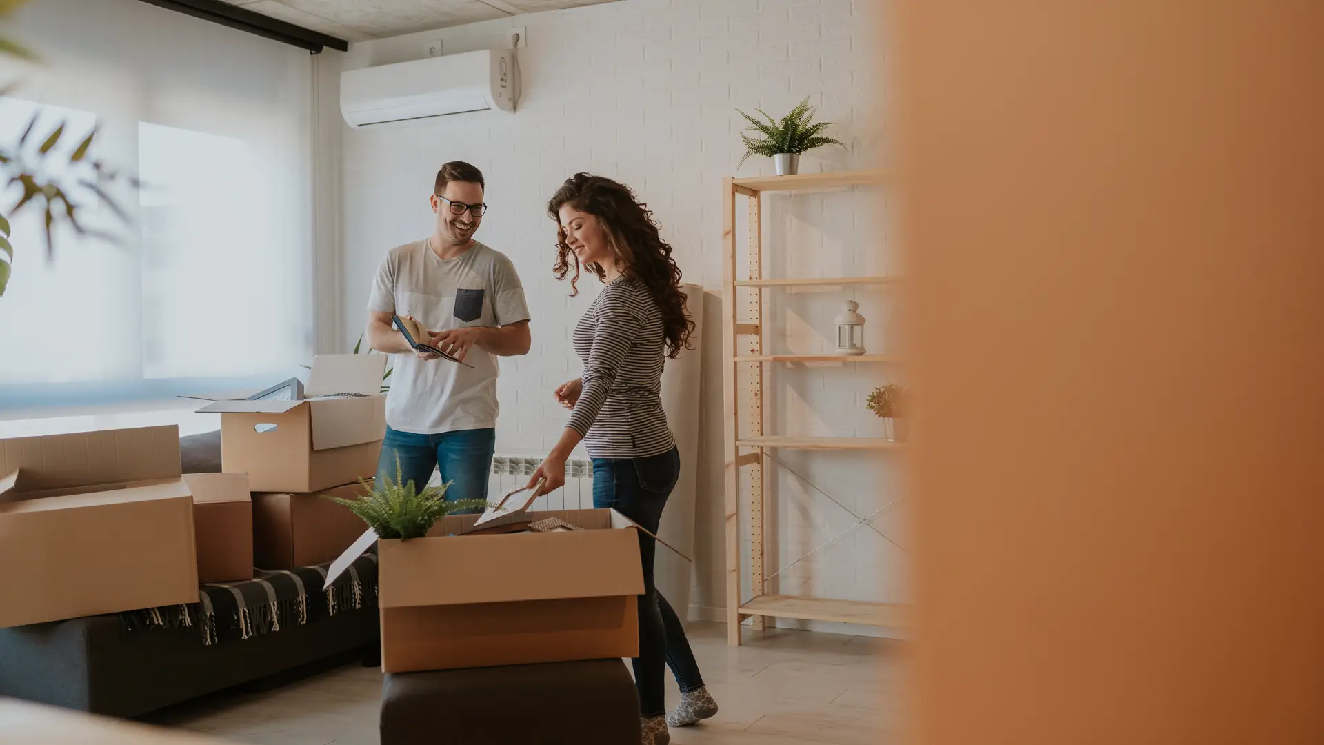 Young couple in their home moving with a Vodafone active contract 